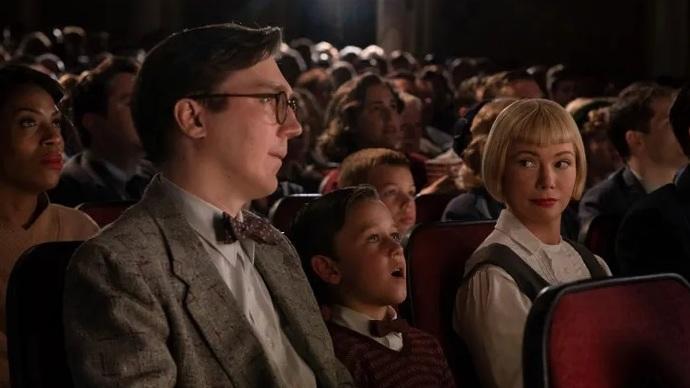 Young Sammy (Mateo Zoryon Francis-DeFord) experiences the magic of the movies with his parents (Paul Dano and Michelle Williams) in <em>The Fabelmans.</em>
