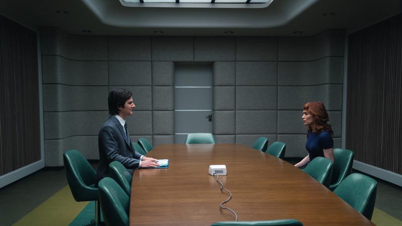Mark (Adam Scott) greets new employee Helly (Britt Lower) in the Apple TV series <em>Severance.</em>