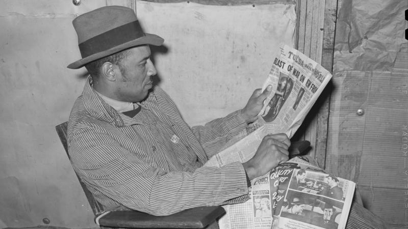 Ken Burns' new three-part documentary, The U.S. and the Holocaust, explores what everyday Americans knew — or didn't know — about what the Nazis were doing in Europe. Above, a tenant farmer reads a newspaper in Creek County, Okla., in February 1940. 