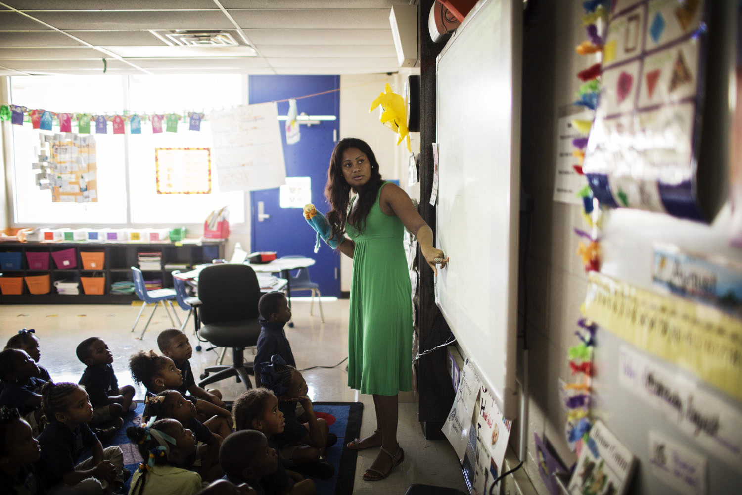Kindergarten teacher Cassondra Bell teaches a lesson to students in SHINE (Sit up straight. Hands folded. In your own space. No noise. Eyes on the speaker) position at KIPP Central City Primary.
